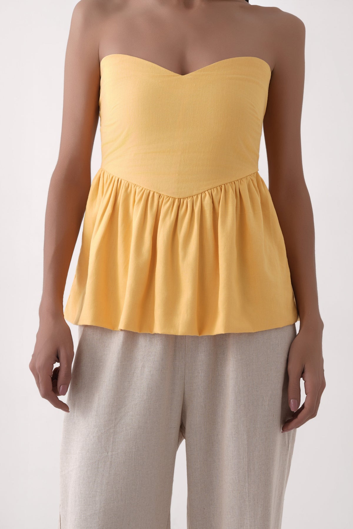 mustard strapless bubble hem peplum top
