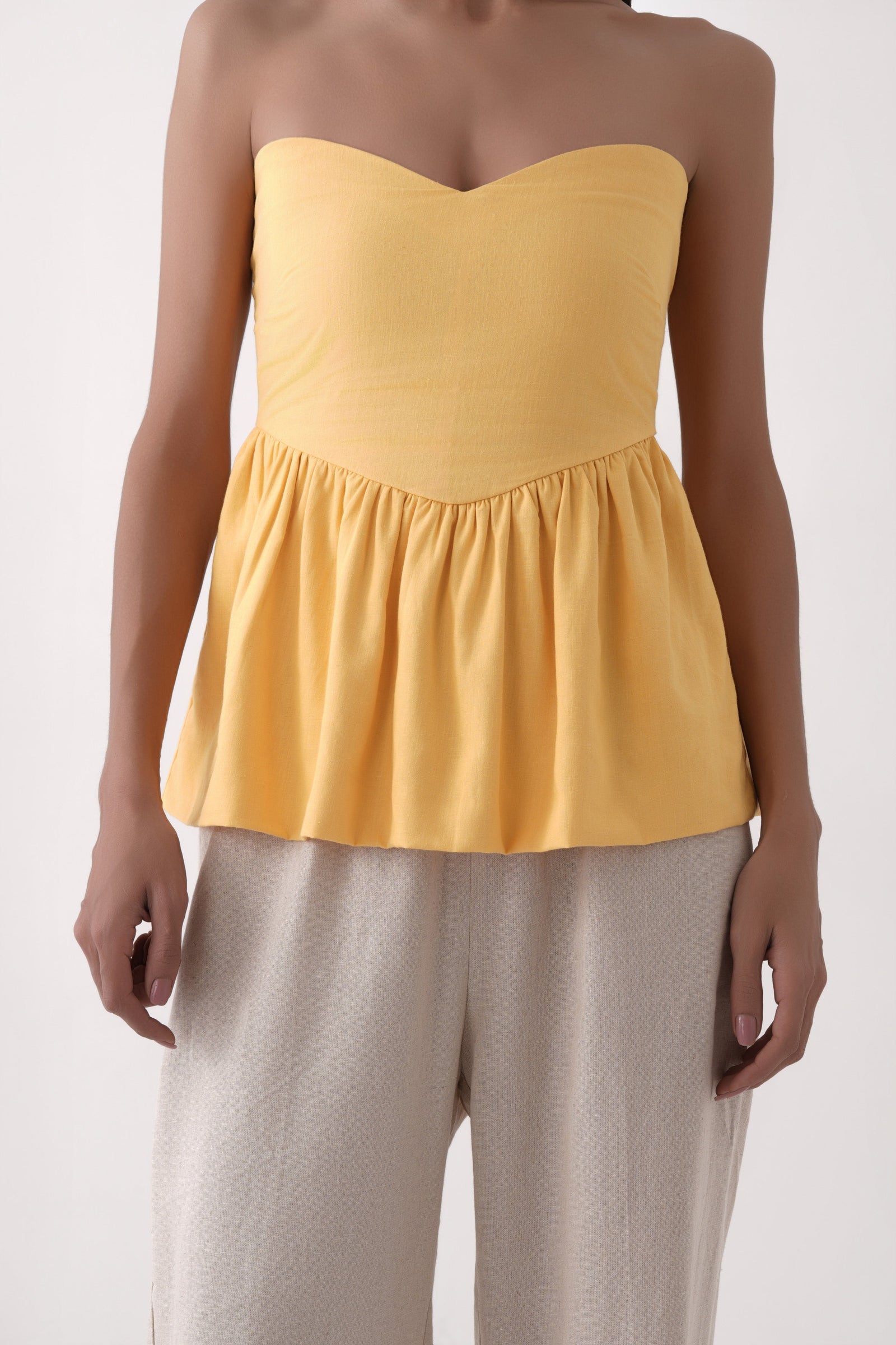mustard strapless bubble hem peplum top